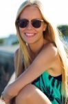 Pretty Blonde Girl Sitting On The Roof Stock Photo