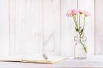 Blank Notebook With Flower On White Wooden Table Stock Photo