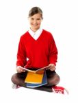 School Girl Seated On Floor Stock Photo