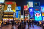 Tourist Walking In Night Shopping Street At Dotonbori In Osaka, Japan  Stock Photo