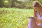 Beautiful Woman With Tablet Computer In Park Stock Photo