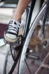 Person Riding A Vintage Bicycle, Close Up View Of Sneaker Shoe A Stock Photo