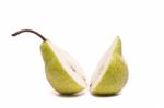 Green Pear Sliced In Half On White Stock Photo