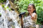 Girl Using Binoculars In Forest Stock Photo