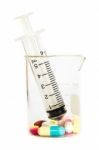 Syringe In Beaker And Group Of Drugs Stock Photo