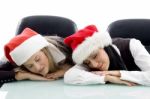 Young Corporate Wearing Christmas Hat And Sleeping Stock Photo