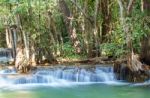 The Water Flowing Over Rocks And Trees Down A Waterfall At Huay Mae Khamin Waterfall National Park ,kanchana Buri In Thailand Stock Photo