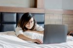 Happy Young Businesswoman Wear Glasses Working On Laptop In Bedr Stock Photo