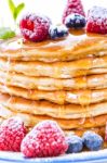 Pile Of Pancakes With Blueberries And Raspberries Sprinkled With Stock Photo