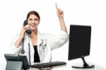 Female Physician Answering Phone Call Stock Photo