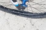 Bicycle Wheel With Flat Tyre On The Concrete Road Stock Photo