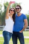 Happy Young Couple Taking Selfies With Her Smartphone In The Par Stock Photo