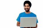 Smiling Young Guy Using His Laptop Stock Photo