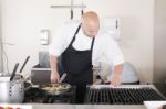 Professional Chef Cleaning The Kitchen Stock Photo