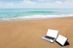 Laptop ,tablet And Smartphone On The Beach In Summer Time Stock Photo