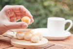 Woman's Hand Holding Mini Chinese Cakes Stock Photo