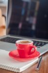 Red Coffee Cup With Notepad And Laptop Stock Photo