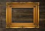 Old Brown Picture Frame On Wooden Background Stock Photo