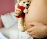 Mom With Teddy Expecting A Baby Stock Photo