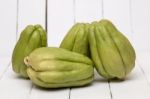 Chayote Fruit On White Wood Background Stock Photo