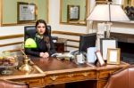 Pretty Woman Posing At Reception Desk Stock Photo