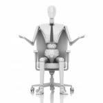 Businessman Doll Sitting On Chair Stock Photo