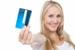 Young Woman Showing Credit Card To Camera Stock Photo