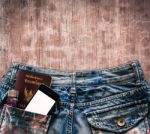 Blue Jeans With Cell Phone, Flashlight And Passport In A Pocket Stock Photo