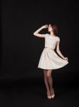 Young Beautiful Girl In A Light Dress Looking Up Stock Photo