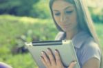 Beautiful Woman With Tablet Computer In Park Stock Photo