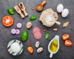 The Ingredients For Homemade Pizza On Dark Sthe Ingredients For Stock Photo