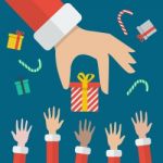 Santa Hand Giving Christmas Gift Box Stock Photo