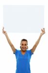 Woman Holding Up Blank White Ad Board Stock Photo