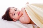 Little Baby Lying In White Towel And Wrapped With Yellow Towel Stock Photo