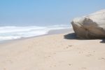 Small Cliff At A Beautiful Beach In Praia Del Rey Stock Photo