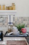 Set Of Plates And Dish On Counter In Kitchen Room Stock Photo