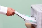 Man Fixing Paper Into Printer Stock Photo