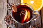 Mulled Wine And Spices On Weathered Wooden Table Stock Photo