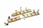 Miniature Worker Team Building Word Happy New Year On White Background Stock Photo