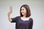 Portrait Of Thai Adult Student University Beautiful Girl Using Her Smart Phone Selfie Stock Photo