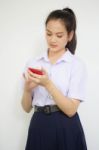 Portrait Of Thai High School Student Uniform Teen Beautiful Girl Using Her Phone And Smile Stock Photo