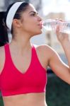 Young Athlete Drinking Water After Exercise Stock Photo