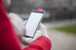 Mobile Phone In Hands With Glowes, Cold Weather Stock Photo