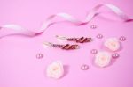 Golden Hairpins With Pink Gemstone On Pink Background Stock Photo