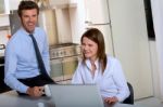 Businesspeople In Kitchen Stock Photo