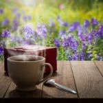 Hot Coffee And Gift Box On Wooden Table In The Meadow Stock Photo