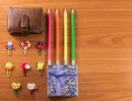 Pencils, Giftbox, Leather Bag And Paperclips Background Stock Photo