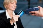 Corporate Lady Swiping Her Card To Pay Stock Photo