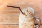 Glass Of Iced Coffee On Wooden Table With Vintage Filter Style Stock Photo