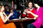 Friends Enjoying Dinner At A Restaurant Stock Photo